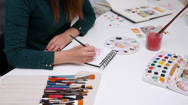 Young female illustrator telecommuting in her home office