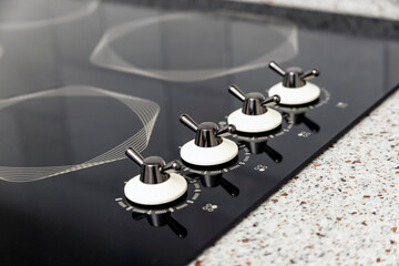 Built-in modern electric induction cooktop with stylish original burners and heat zones