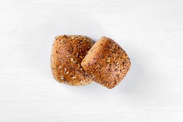Whole wheat rolls isolated on a white background, top view, copy space