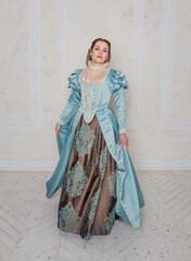 Beautiful young woman in medieval style dress turning