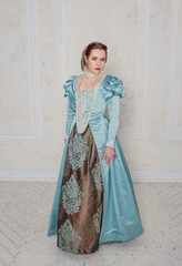 Beautiful young woman in medieval style blue dress