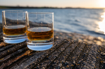 Drinking single malt Scotch whisky at sunset with sea, ocean or river view, private whisky tours in Scotland, UK