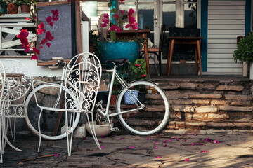 Fototapeta na wymiar Retro and vintage. A bicycle in a city cafe with flowers in the Provencal style.