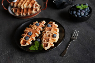 Сroffle, trendy crispy korean  baked goods, top view on black background, selective focus