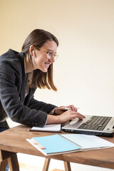 Young woman works in front of a laptop