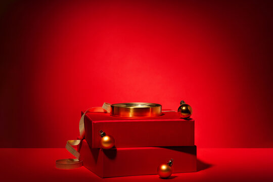 Red podium of gift boxes golden circle, decor on red background.
