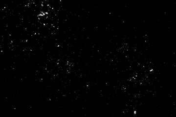 Sea salt is scattered on the black surface of the table.