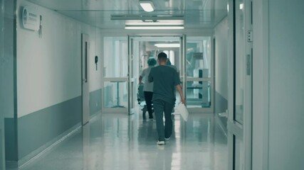 Hospital corridor with a group of doctors walking away