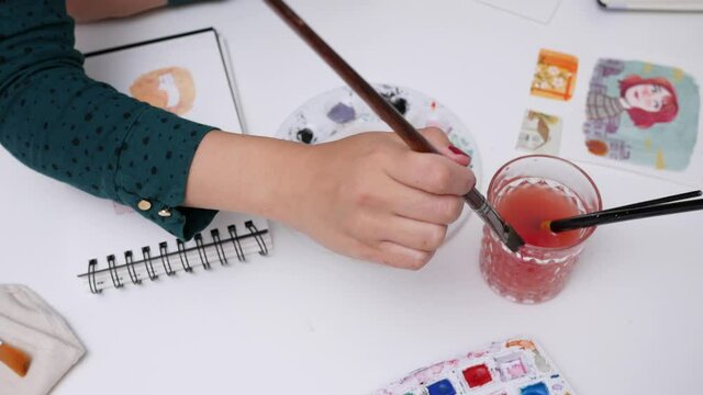 Young female illustrator telecommuting in her home office