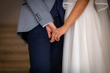 Low angle view bride and groom holding hands together and show affection