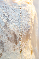 Close up white classic wedding dress tiny flowers ornaments with buttons set