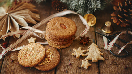 Obraz na płótnie Canvas Merry Christmas! Christmas oatmeal cookies and festive decorations on rustic wooden table. Atmospheric stylish christmas panoramic image with healthy cookies and xmas decor. Happy holidays