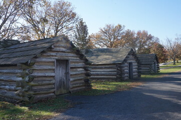 Three Log Cabins on Sunny Autumn Day
