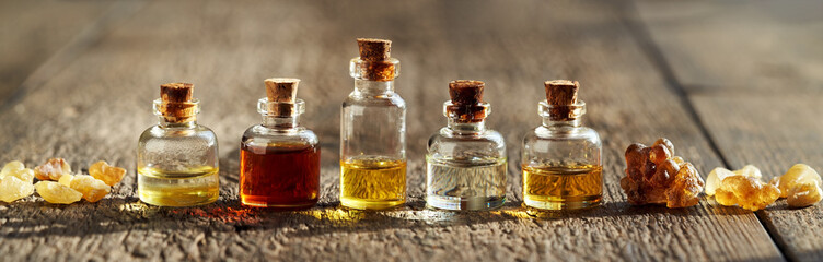 Panoramic banner or header with essential oil bottles and frankincense resin crystals
