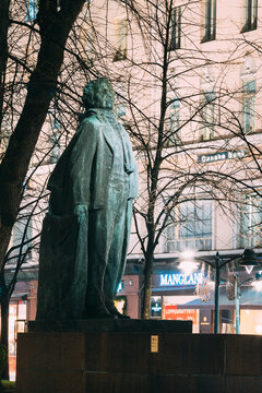 Helsinki, Finland. Evening View Of Monument To Finnish Poet And Journalist Eino Leino In Esplanade Park