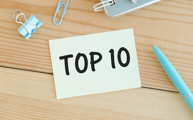 Top 10 written on paper sheet on wooden background
