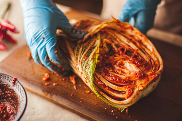 The process of making traditional Korean kimchi from napa cabbage - obrazy, fototapety, plakaty