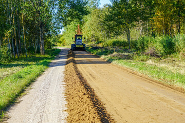 gravel road leveling in rural areas with the help of a grader