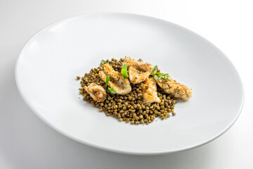 Plate with Grated squid with crispy lentils