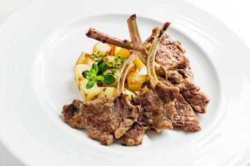 Plate with lamb ribs and potatoes