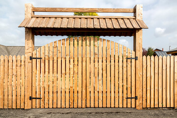 Big wooden gate with metal knobs