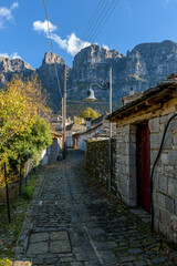 view of traditional architecture  with   stone buildings and background astraka mountain during  fall season in the picturesque village of papigo , zagori Greece