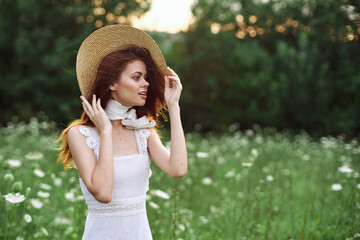 Woman with hat in a field of flowers nature freedom