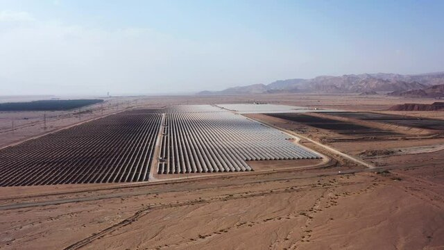 Aerial View of Solar Panel Park or farm Solar panels in the desert among the mountains in Timna, Israel. Drone Aerial Shot Of Power Station Over Landscape On Sunny Day Against Sky at the Negev, Israel