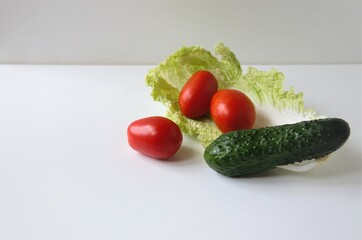ingredients of vegetable salad on a white background, minimalism