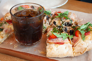 Delicious italian pizza with cola soda with ice
