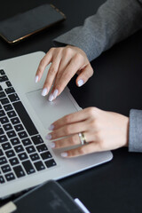 person typing on the keyboard. girl typing on the computer.office. notepad and computer. office worker. laptop on table