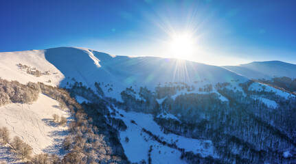 Magical winter panorama of beautiful snowy slopes