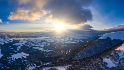 Picturesque winter panorama of snowy mountain hills