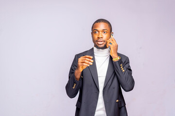 black business man on suit talking on cell phone isolated on a white studio background