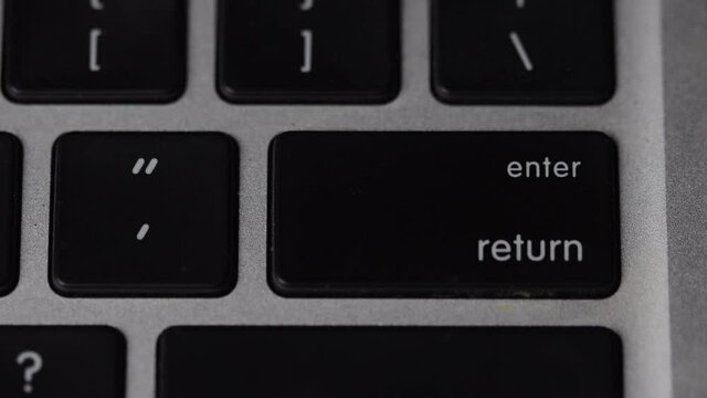 Finger pressing enter - return key on keyboard. Macro view