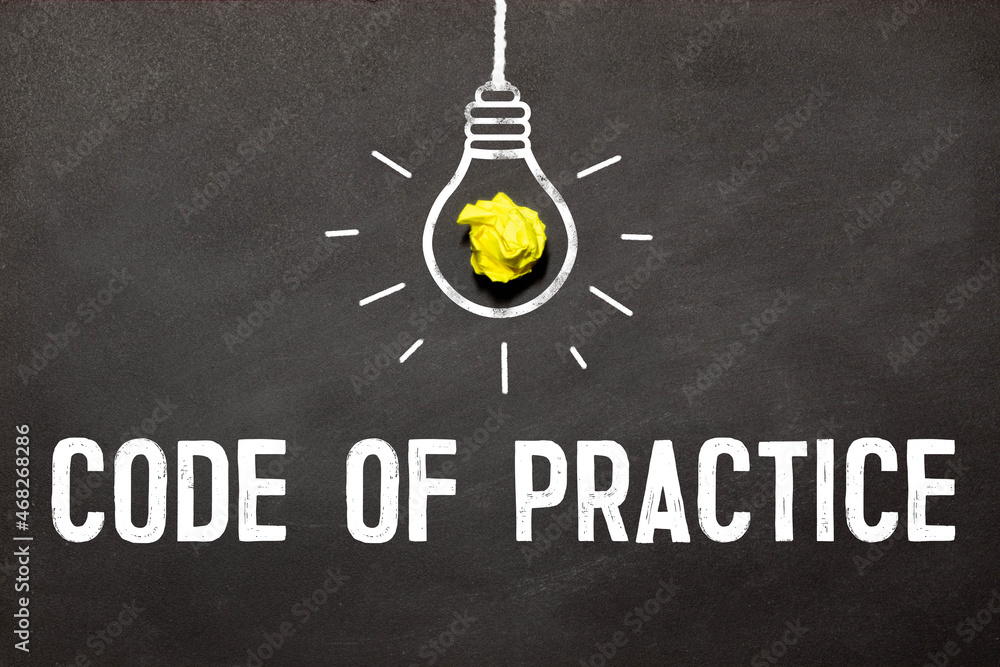 Poster code of practice text written on a notebook with pencils