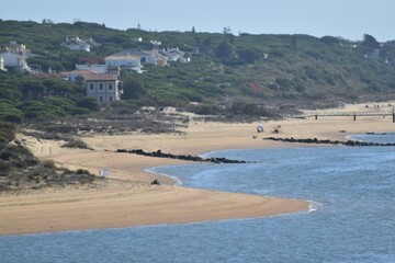 
Nature, houses, beach, persons and the sea in the coast of Huelva, Spain