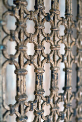 A wooden decoraive beautiful lattice on the doors of silver color. Background of decorative lattice in a shallow depth of field. Vintage style.