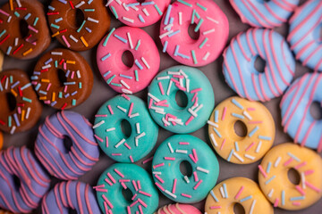 Donats from sugar paste. Multi-colored sugar art cakes. Different types of colorful Donats decorated sprinkles and icing. Cake art concept image