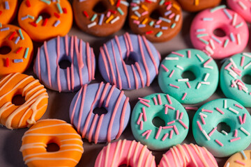 Donats from sugar paste. Multi-colored sugar art cakes. Different types of colorful Donats decorated sprinkles and icing. Cake art concept image