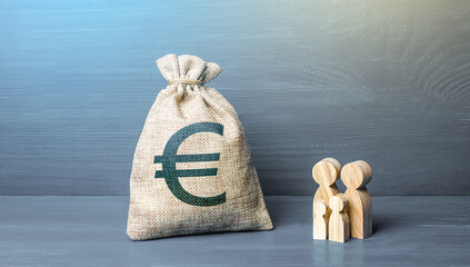 Family figurines and euro money bag. Social policy, family budget. Investment in human capital....