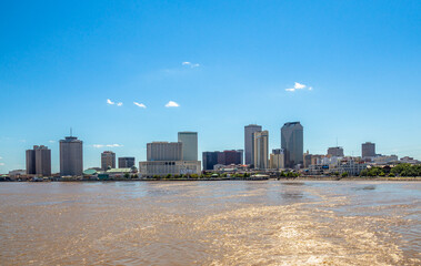 New Orleans city panorama from Mississippi River with business district skyscrappers and river promenade, Louisiana, USA