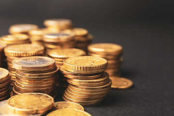Heap of golden coins on dark background, closeup