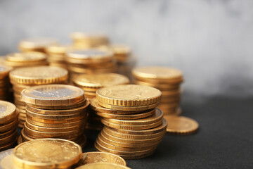 Heap of golden coins on dark background, closeup