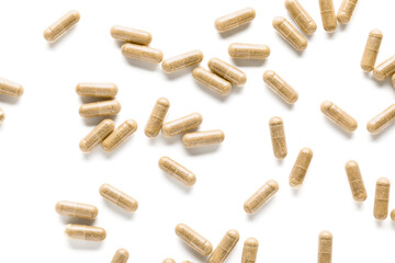 Vitamin K pills scattered on white background - obrazy, fototapety, plakaty