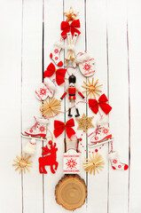 Fototapeta na wymiar Christmas tree made of wooden toys on a white background. Toys made from natural materials. Top view .