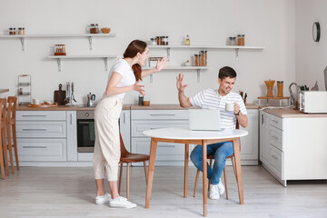 Young couple arguing in kitchen