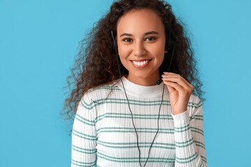 African-American consultant of call center in headset on blue background