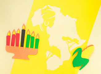 Happy Kwanzaa Greeting Card Background. Candleholder made from paper leaves. Paper art concept