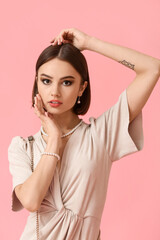 Fototapeta premium Portrait of fashionable woman with stylish accessories on color background